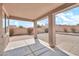 View of the covered patio and spacious backyard with desert landscaping and block wall at 7207 W Alta Vista Rd, Laveen, AZ 85339