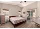 Bright bedroom features a large window, sliding glass door, hardwood floors, and a vaulted ceiling at 7826 W Mcrae Way, Glendale, AZ 85308