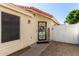 Welcoming front door with decorative wrought iron security door and 'HOME' sign, complemented by a white fence at 7826 W Mcrae Way, Glendale, AZ 85308