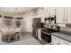 Bright eat-in kitchen with stainless steel appliances, dining area, and ample counter space at 7826 W Mcrae Way, Glendale, AZ 85308