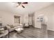 Bright living room with an archway into the kitchen featuring vinyl floors, and neutral decor at 7826 W Mcrae Way, Glendale, AZ 85308