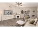 Spacious living room featuring a fireplace, modern decor, and vinyl flooring at 7826 W Mcrae Way, Glendale, AZ 85308