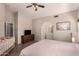 Main bedroom with wood dresser, neutral walls, ceiling fan, and views to the bathroom at 7826 W Mcrae Way, Glendale, AZ 85308