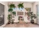 Covered sunroom with tropical plants, tile flooring, and view of the pool area at 7826 W Mcrae Way, Glendale, AZ 85308