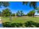 Expansive community playground featuring lush green grass and shaded play structures for children to enjoy at 7826 W Mcrae Way, Glendale, AZ 85308