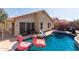 Backyard pool area with flamingo floats, slide, patio furniture, and enclosed fence at 7826 W Mcrae Way, Glendale, AZ 85308