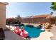 Backyard features a pool with a waterfall feature and patio furniture for entertaining at 7826 W Mcrae Way, Glendale, AZ 85308