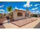 Well-maintained home featuring desert landscaping, arched accent windows and carport on a sunny day at 8103 E Southern #303 Ave, Mesa, AZ 85209