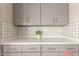 Close up shot of kitchen countertops, tile backsplash, and upper cabinets at 8103 E Southern #303 Ave, Mesa, AZ 85209