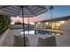 Backyard with a refreshing pool, palm trees, and lounge seating at 8403 E Fairmount Ave, Scottsdale, AZ 85251