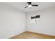 Bright, minimalist bedroom with wood flooring and a ceiling fan at 8403 E Fairmount Ave, Scottsdale, AZ 85251