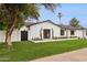 Angle shot of the manicured green lawn and updated modern exterior lighting and black trim at 8403 E Fairmount Ave, Scottsdale, AZ 85251