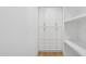 Bright hallway with pantry cabinets and hardwood floors at 8403 E Fairmount Ave, Scottsdale, AZ 85251