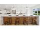 Bright kitchen with an expansive island, stylish seating, and stainless steel appliances for modern living at 8403 E Fairmount Ave, Scottsdale, AZ 85251