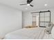 Bedroom featuring white bedding, sliding closet door, and a ceiling fan at 8403 E Fairmount Ave, Scottsdale, AZ 85251
