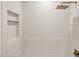 Spa-like shower features horizontal tile, bronze hardware, and a built-in niche for toiletries at 8403 E Fairmount Ave, Scottsdale, AZ 85251