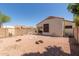View of backyard with desert landscaping, block wall, and view of neighboring tile roofs at 8628 W Maui Ln, Peoria, AZ 85381
