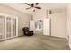 Relaxing bedroom with comfortable recliner, ceiling fan, and plantation shutters at 8628 W Maui Ln, Peoria, AZ 85381