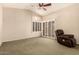 Bright bedroom featuring plantation shutters, ceiling fan, and comfortable carpet at 8628 W Maui Ln, Peoria, AZ 85381