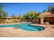 Inviting community pool with desert landscaping, seating, and a shaded patio area at 8628 W Maui Ln, Peoria, AZ 85381