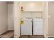 Functional laundry area with included washer and dryer and storage shelves at 8628 W Maui Ln, Peoria, AZ 85381