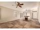 Expansive room featuring tile flooring, ceiling fan, and bright lighting at 8628 W Maui Ln, Peoria, AZ 85381