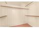 Spacious walk-in closet with ample storage space and multiple shelving units at 8628 W Maui Ln, Peoria, AZ 85381