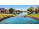 Scenic waterfront view with lush green lawns and picturesque canals lined with beautiful homes at 8628 W Maui Ln, Peoria, AZ 85381