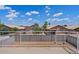 A view from a home's balcony overlooks neighboring backyards and desert landscaping at 8750 W Granada Rd, Phoenix, AZ 85037