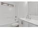 The clean bathroom features a shower-tub combo with white tile, and a white vanity at 8750 W Granada Rd, Phoenix, AZ 85037