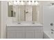Bright bathroom features a double sink vanity with modern fixtures and a shower-tub combo at 8750 W Granada Rd, Phoenix, AZ 85037