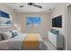 Stylishly furnished bedroom featuring neutral walls, carpet, and a bright sunny window at 8750 W Granada Rd, Phoenix, AZ 85037