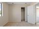 Bedroom featuring neutral carpeting, a closet, and an open door to a hallway at 8750 W Granada Rd, Phoenix, AZ 85037