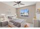 This cozy bedroom features a light-colored wood floor and a sunlit window at 8750 W Granada Rd, Phoenix, AZ 85037