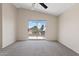 Bedroom with ceiling fan and sliding door leading to balcony with view of neighborhood at 8750 W Granada Rd, Phoenix, AZ 85037