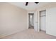 Bright bedroom with neutral walls, plush carpet, closet, and ensuite bathroom at 8750 W Granada Rd, Phoenix, AZ 85037
