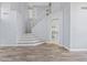 Spacious foyer featuring a staircase, hardwood floors, and an open layout leading to the kitchen and living areas at 8750 W Granada Rd, Phoenix, AZ 85037