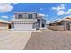 Charming two-story home featuring a well-maintained front yard with a spacious driveway and attached two-car garage at 8750 W Granada Rd, Phoenix, AZ 85037