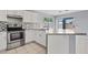 Bright kitchen featuring stainless steel appliances, granite countertops, and white cabinetry at 8750 W Granada Rd, Phoenix, AZ 85037