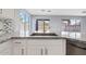 Kitchen sink and granite countertops with a view to the backyard and stainless steel dishwasher at 8750 W Granada Rd, Phoenix, AZ 85037