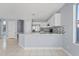 Well-designed kitchen area with a breakfast bar, tile backsplash, and modern finishes enhancing the cooking space at 8750 W Granada Rd, Phoenix, AZ 85037