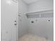 Cozy laundry room featuring a utility sink, door to outside, and overhead shelf at 8750 W Granada Rd, Phoenix, AZ 85037