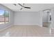 Bright living room with neutral-colored walls and tile floor with a ceiling fan at 8750 W Granada Rd, Phoenix, AZ 85037