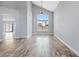 Bright living room features beautiful hardwood floors, high ceilings, and a large window providing ample natural light at 8750 W Granada Rd, Phoenix, AZ 85037