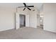 Spacious carpeted main bedroom with access to a walk-in closet and dual sink bathroom at 8750 W Granada Rd, Phoenix, AZ 85037