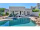 A private backyard showcasing a pool, spa, and the home's architectural design with multiple access points at 8760 N 73Rd Way, Scottsdale, AZ 85258