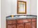Powder room with a dark vanity, granite countertop, and decorative mirror at 8760 N 73Rd Way, Scottsdale, AZ 85258