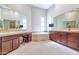 Well-lit bathroom with double vanities, tile flooring, and a large soaking tub at 8760 N 73Rd Way, Scottsdale, AZ 85258