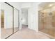 Hallway with a walk-in shower, mirrored closet doors, and neutral colored carpet at 8760 N 73Rd Way, Scottsdale, AZ 85258