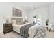 Bright bedroom with a ceiling fan, upholstered bed and access to the yard at 8760 N 73Rd Way, Scottsdale, AZ 85258